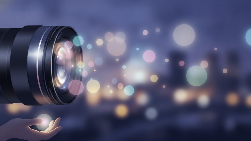 A camera lens with soft glowing bokeh circles of light illustrating photography depth and background blur.